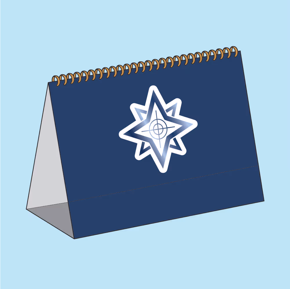 Blue desktop spiral calendar with a white and blue star-shaped target logo on the front.