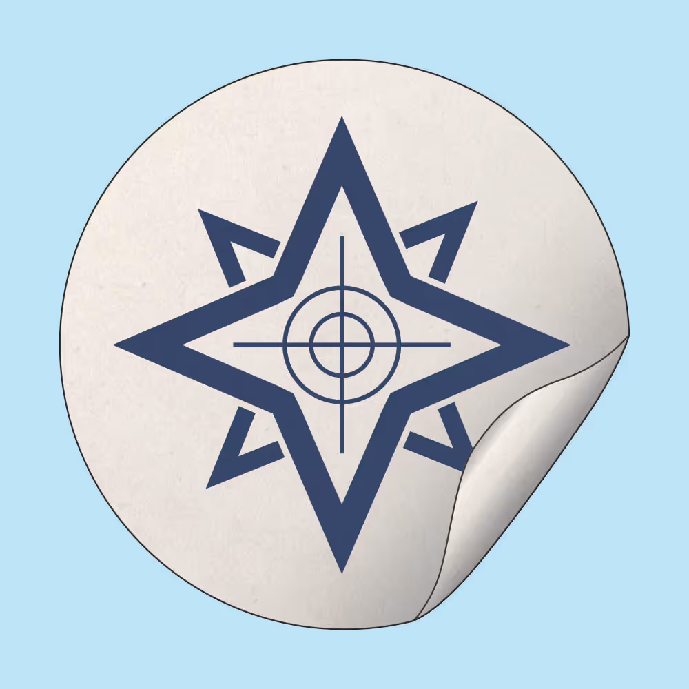 Round white sticker with a dark blue compass rose design and a partially peeled corner on a light blue background.
