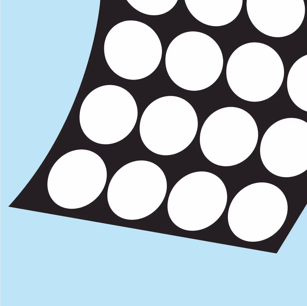Close-up of a black sheet with evenly spaced large white dots on a light blue background.